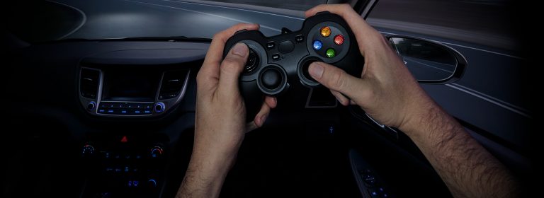 Driver using a gaming controller to handle a vehicle instead of a steering wheel