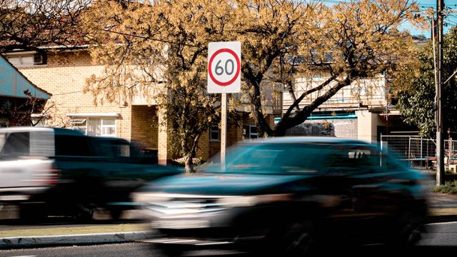 Car speeding down the road in a 60 km/h zone