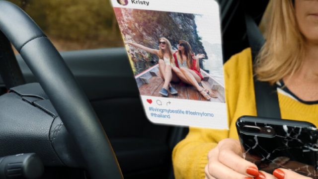 Driver looking at Instagram pictures while driving