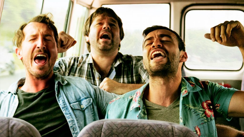 A group of mates singing in the car