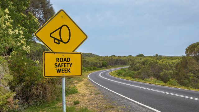 A road sign stating 'Road safety week'