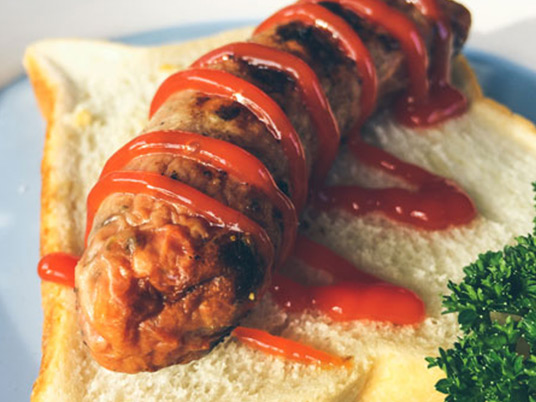 Sausage served on a piece of bread