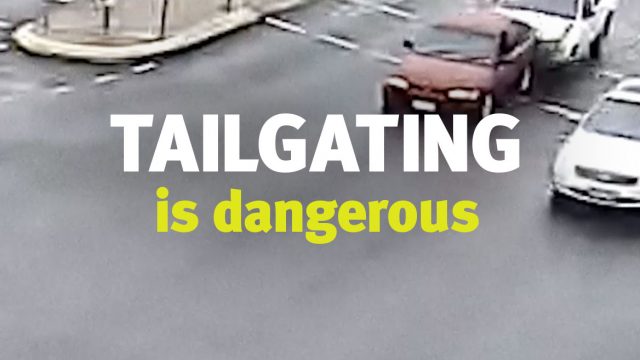 Screenshot from traffic light CCTV footage that says 'Tailgating is dangerous'