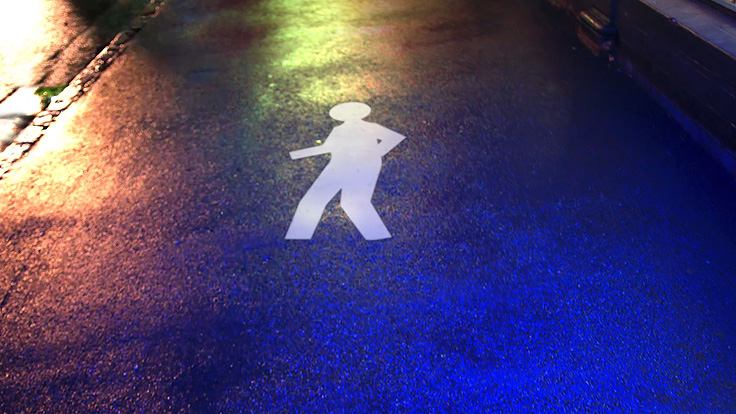 White walking man symbol painted on road