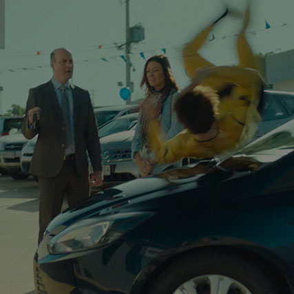 A man and a woman witnessing a young man be hit by a car as a test instead of a dummy