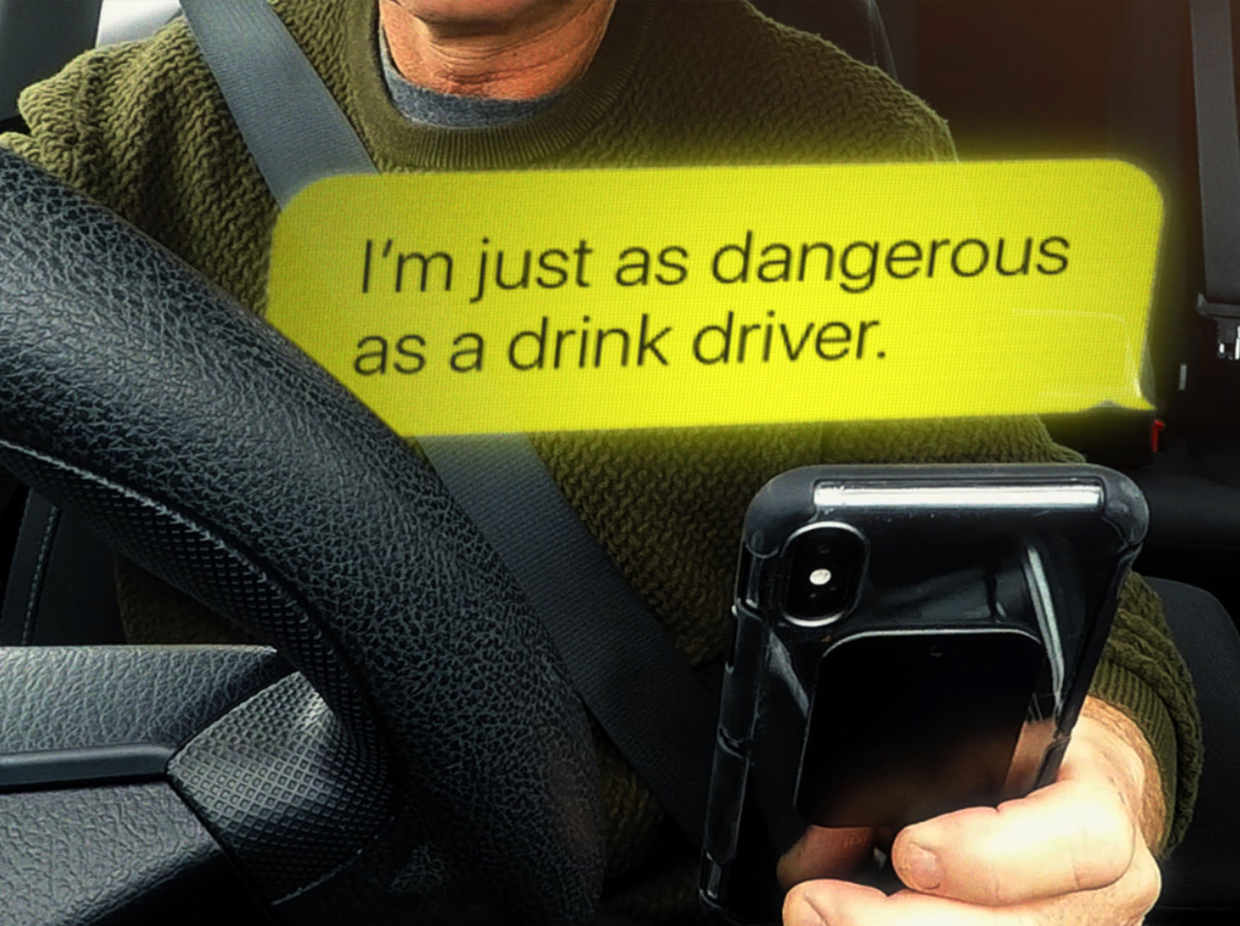 Man texts while driving with the message 'I'm just as dangerous as a drink driver'