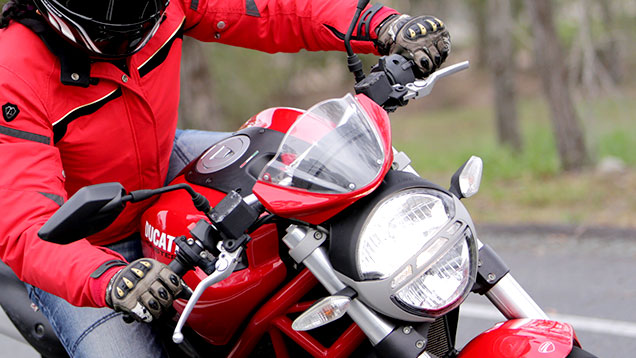 Motorbike rider with gloves on