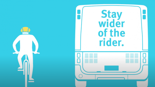 A graphic of a bike rider next to a bus that says 'Stay wider of the rider.'