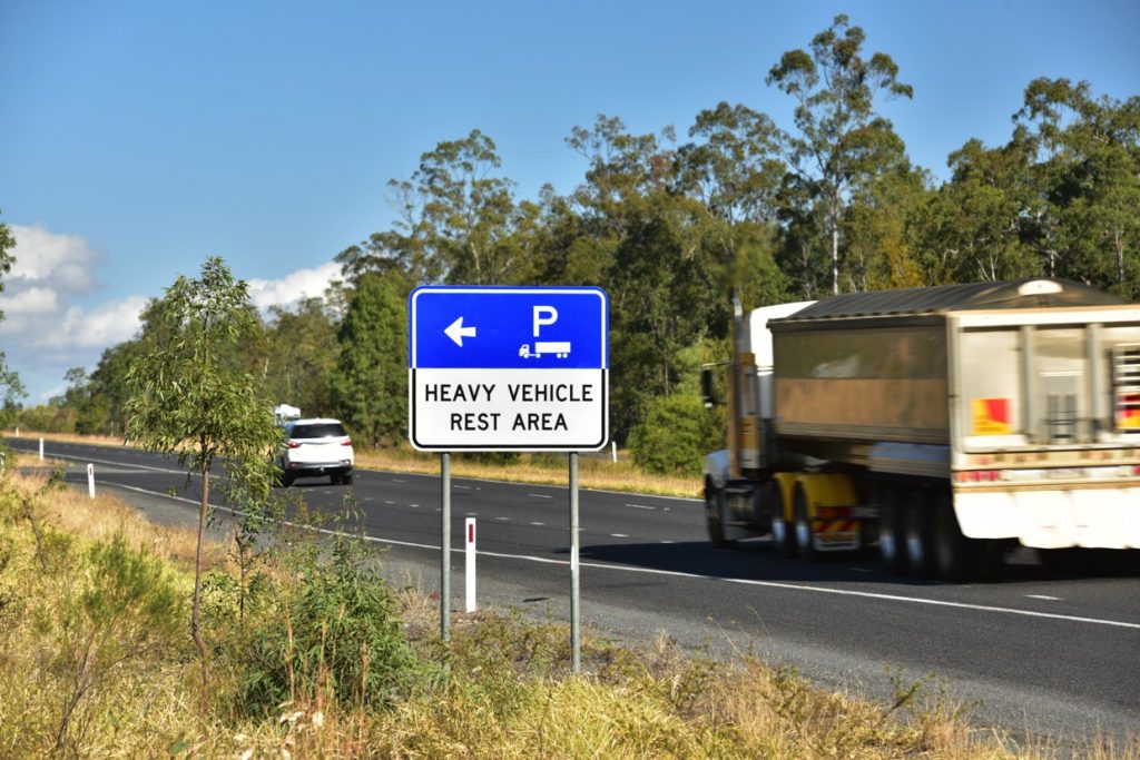 Road sign that says heavy vehicle rest area and indicates it is ahead.