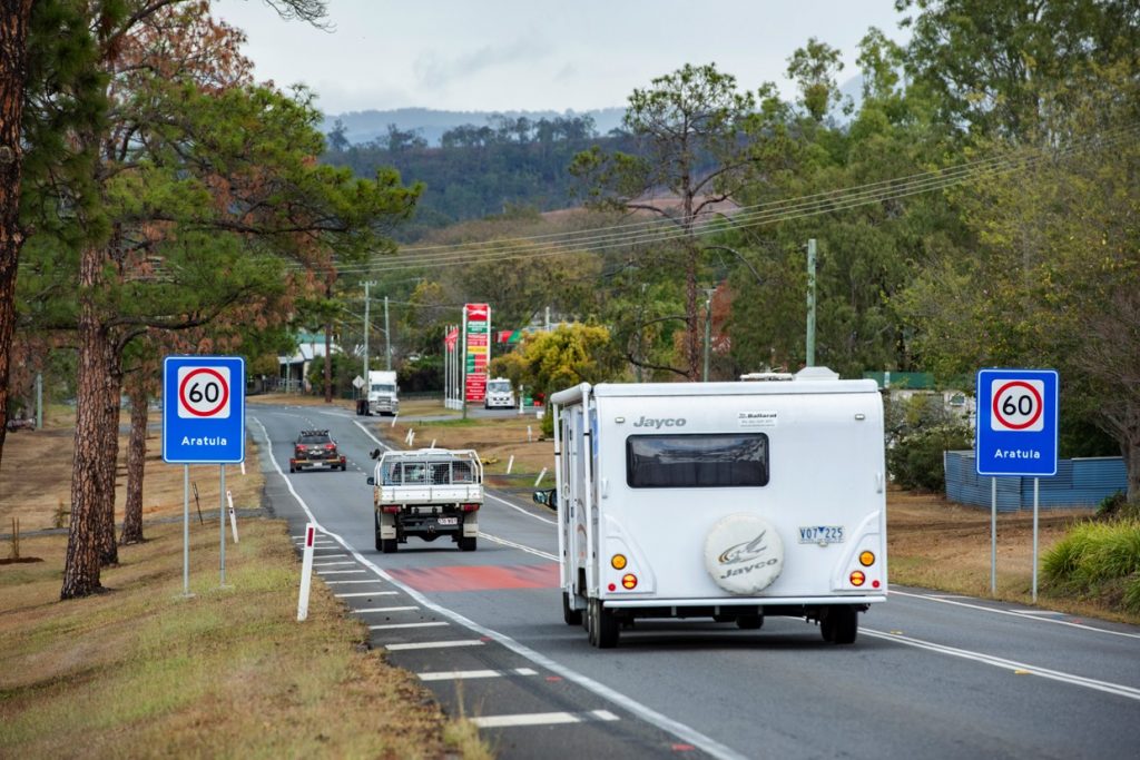 Caravan drives behind a car down in a 60 zone in regional Queensland