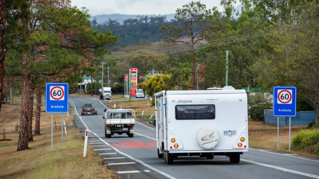 Caravan drives behind a car down in a 60 zone in regional Queensland