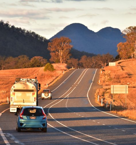 A car following a caravan on a regional road